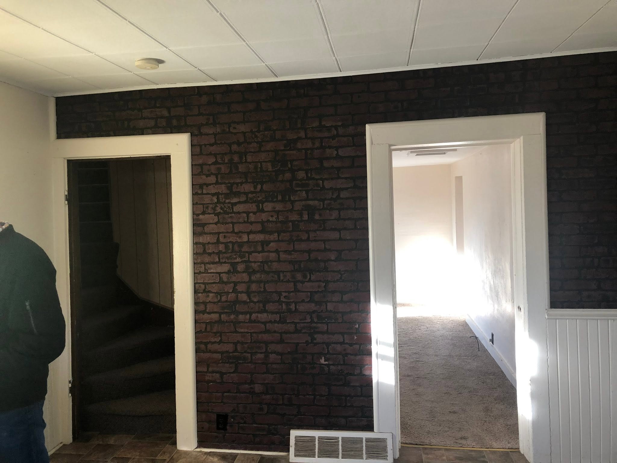 Completed Basement Renovation with Custom Wainscoting and Restored Brick by C-n-J Construction